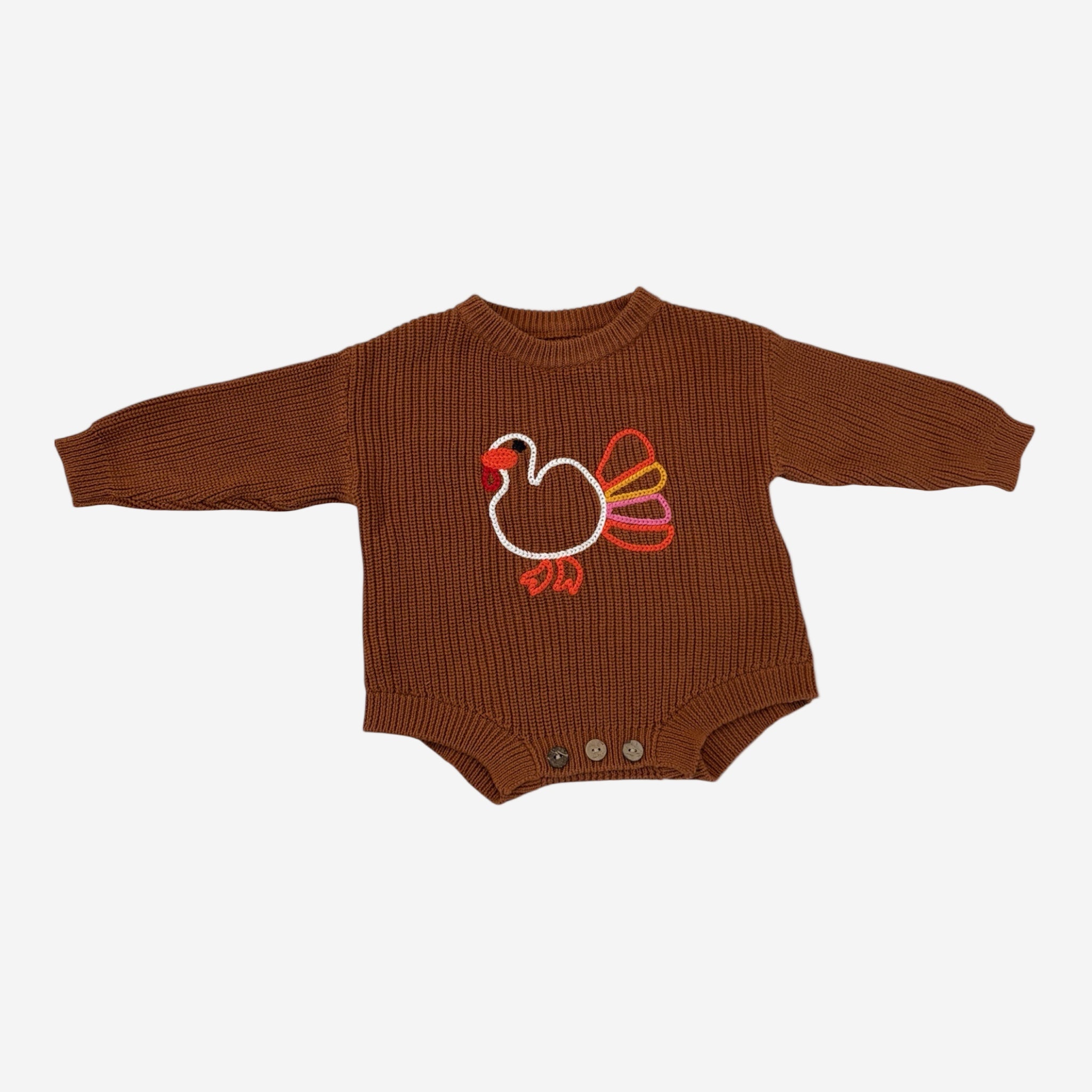 Brown baby romper with a embroidered turkey design on a white background