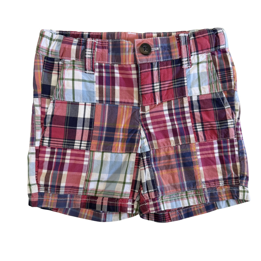 Plaid shorts with a button on a white background